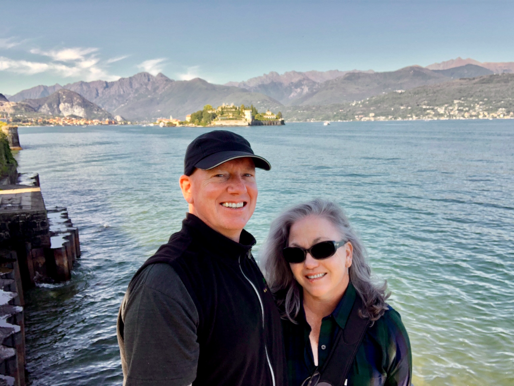Man and woman standing in front of lake